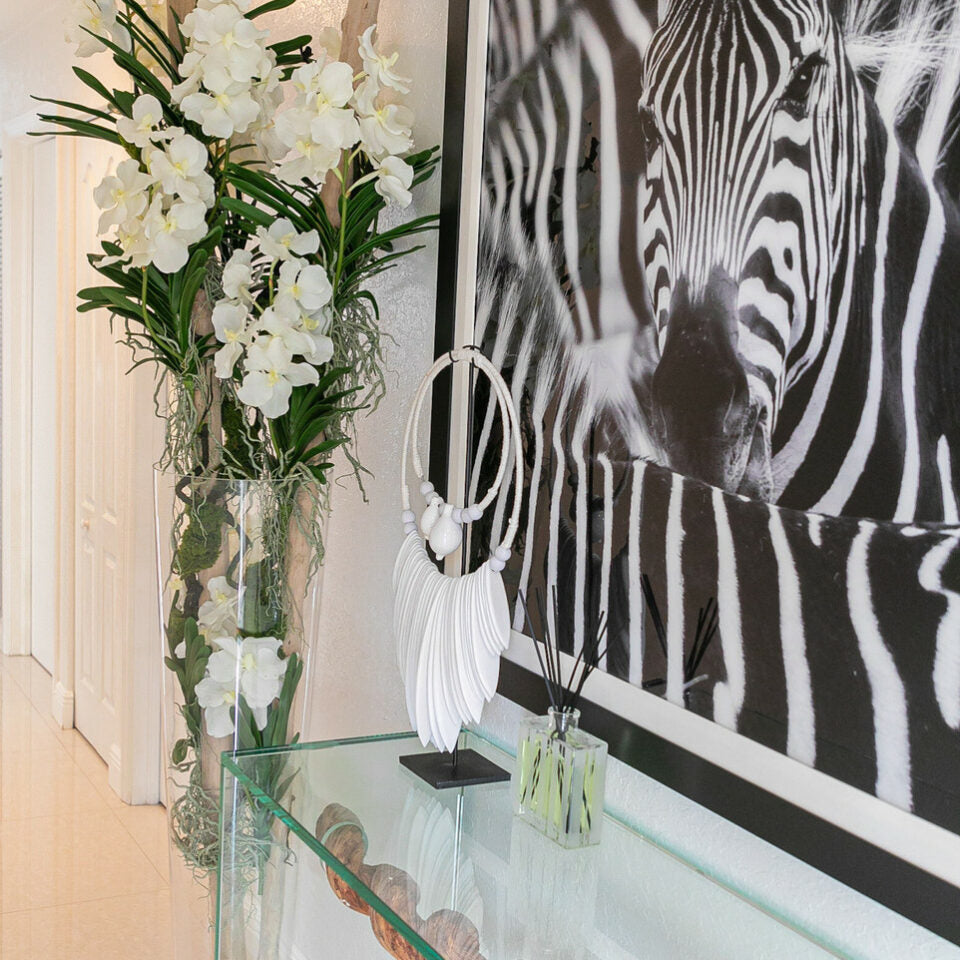 White Vanda Orchids and Driftwood Inside a Large Conical Glass Cylinder